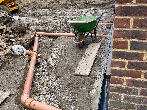 Site excavation for the drainage system in a Cobham garden