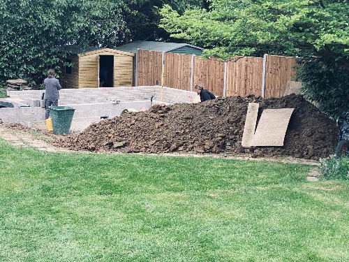 Rear garden seating area with raised planters and K-Rend wall in Esher