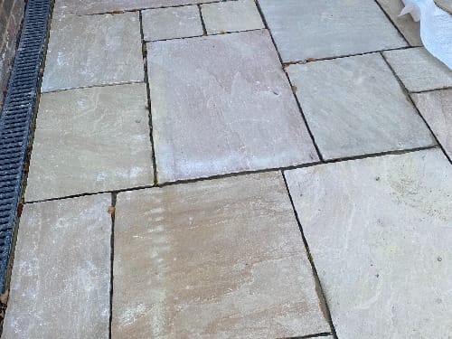 Indian sandstone patio in a garden in Ockley, Surrey, by Flourish Landscaping