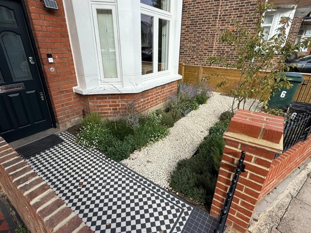 Restored Victorian encaustic tiled path in a Kingston front garden with a period bay-fronted house, by Flourish Landscaping