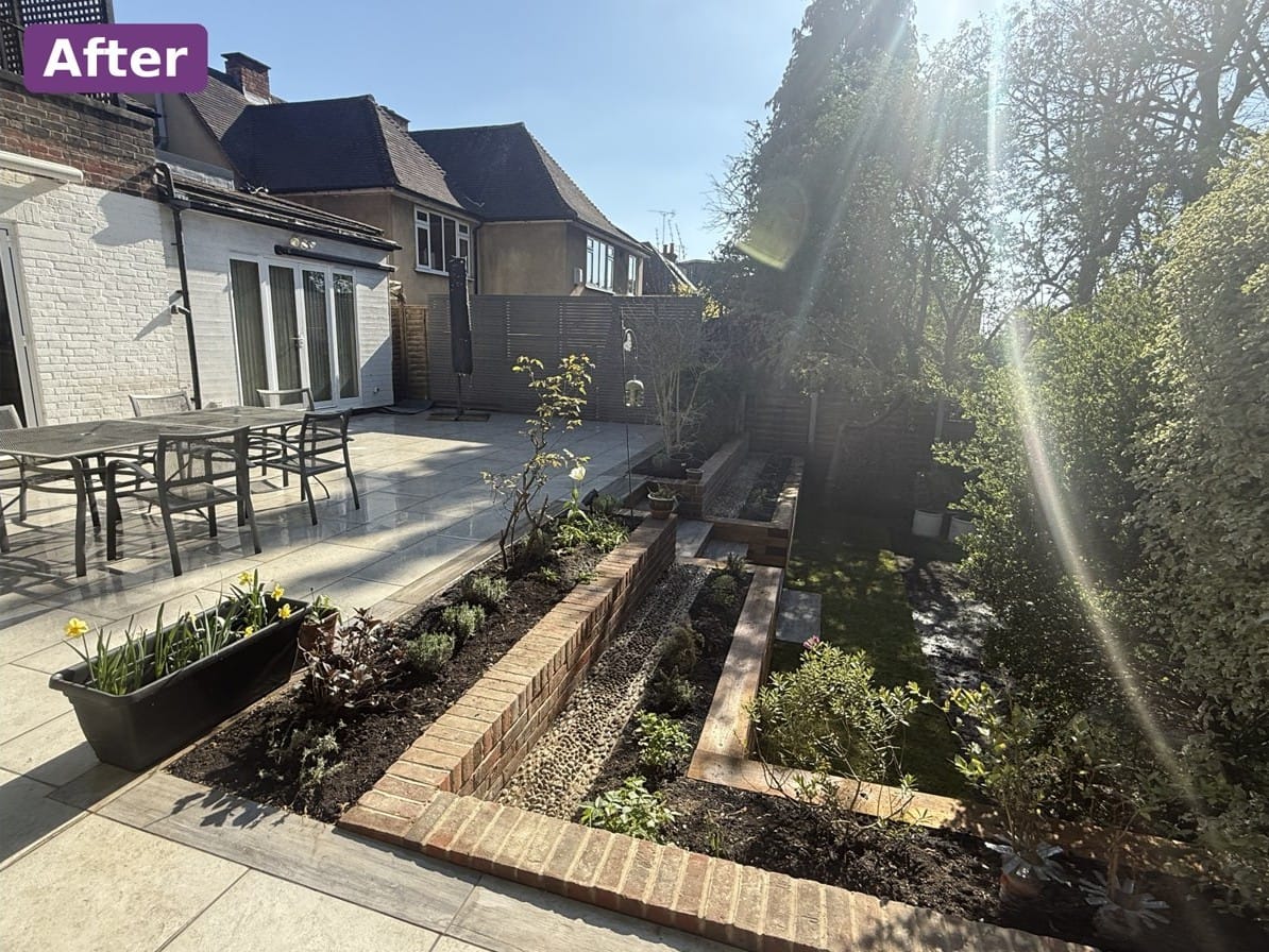 New porcelain patio and brick-edged raised beds with fresh planting in a Kingston upon Thames garden